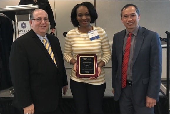 Mitchel Rothholz and L.J. Tan present April Green of Oschner and Associates with the Adult Immunization Champion Award. Courtesy of National Adult and Influenza Immunization Summit